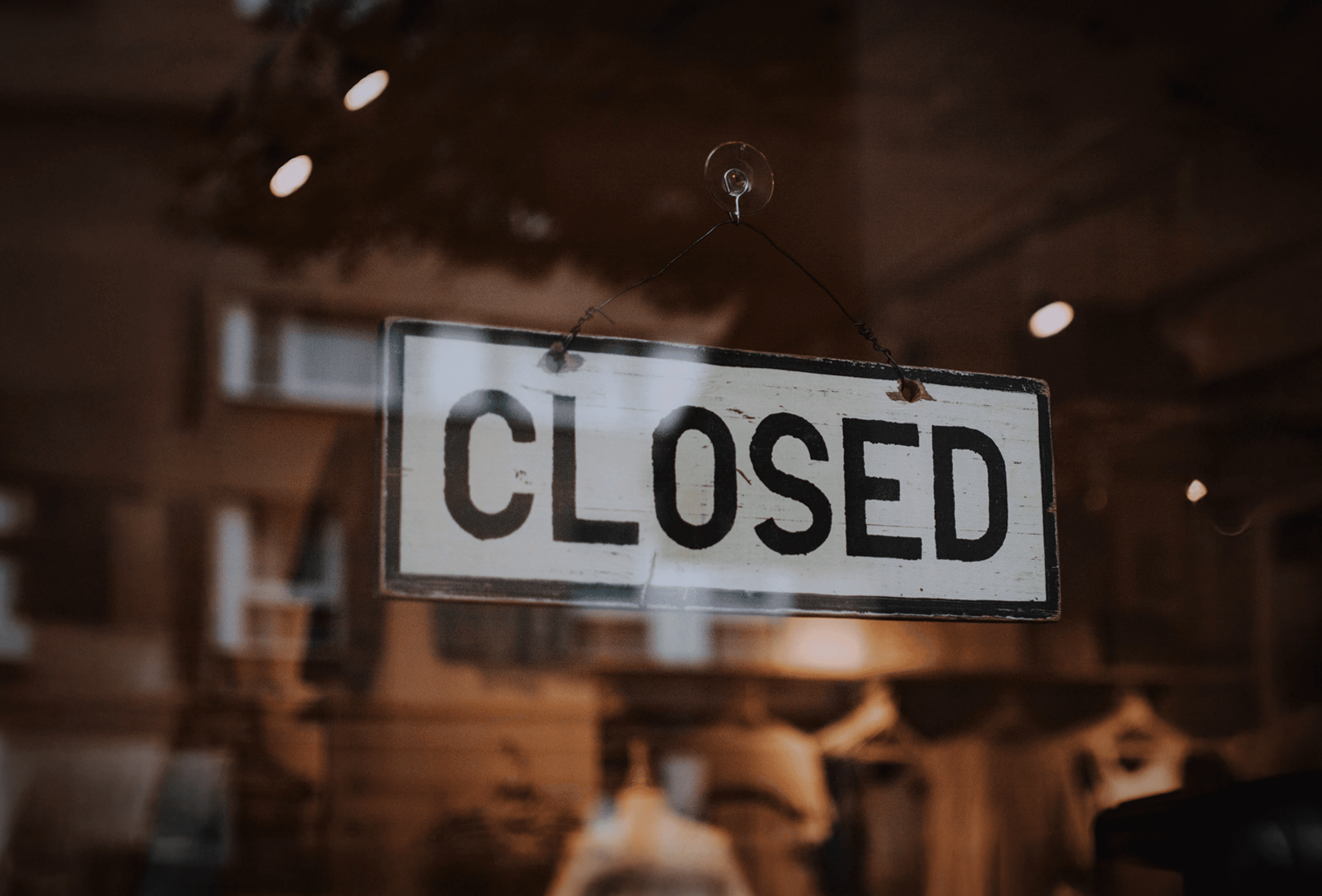 Business window with a 'CLOSED' sign